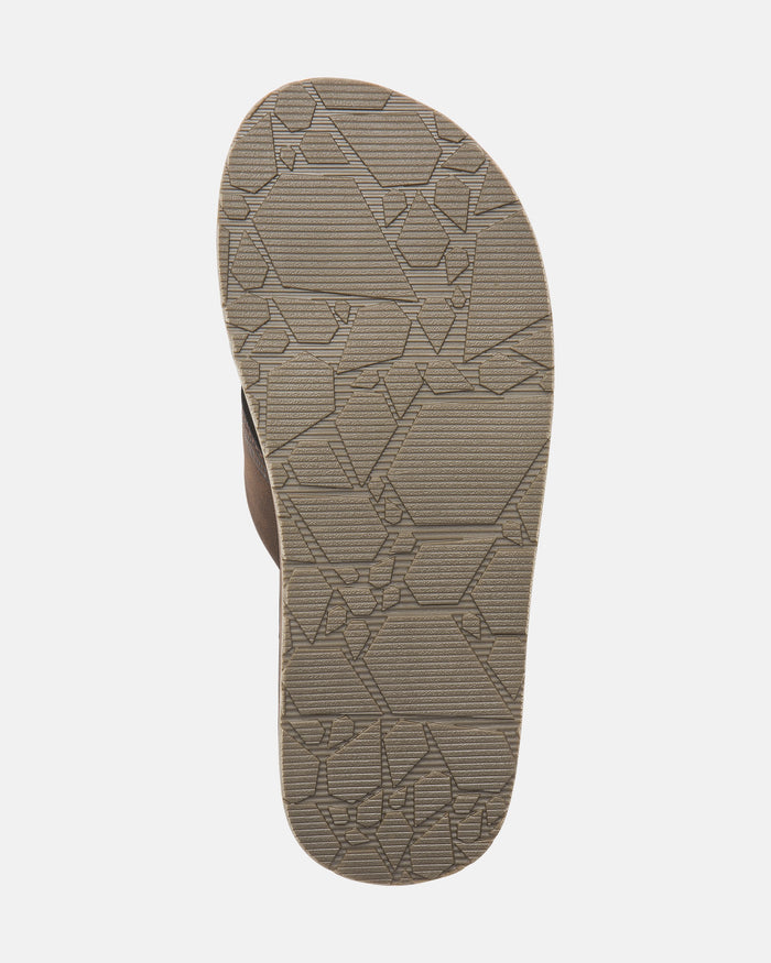 The image shows the bottom sole of a brown Volcom Men's Recliner sandal featuring an extra grippy geometric tread for superior traction, displayed on a plain white background.