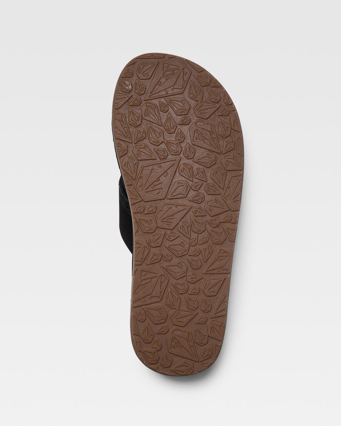The image shows the brown sole of a Volcom Recliner sandal, featuring a leaf and geometric pattern, photographed from the bottom against a plain white background.
