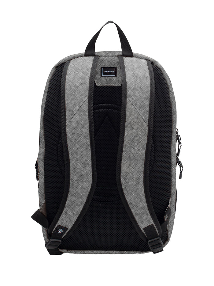 The Men's Roamer 3 Backpack by Volcom is displayed in gray from the back, showcasing ergonomic mesh straps with black padding, a top handle, and a small rectangular Volcom logo near the top center. For added convenience and protection, this backpack also features a padded laptop zone.