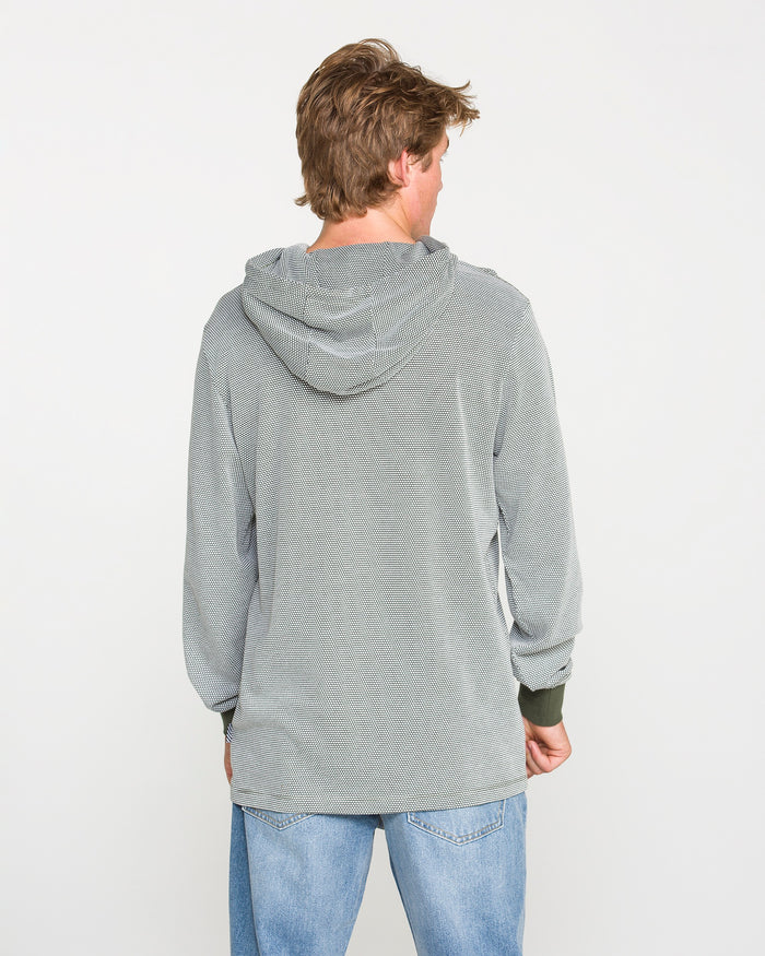 A person with light brown hair, wearing the Volcom Men's Rowan Thermal Long Sleeve Shirt in light gray and blue jeans, is standing facing away from the camera against a plain white background.