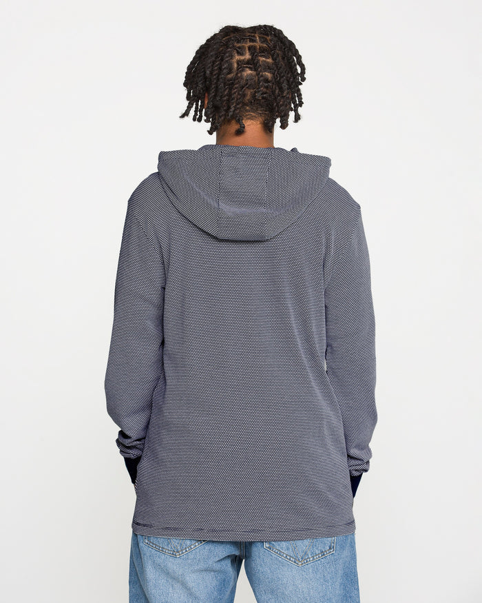 A person with short, twisted braids wears the Volcom Men's Rowan Thermal Long Sleeve Shirt in gray, paired with blue jeans, standing with their back to the camera against a plain white background.