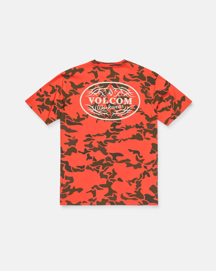 The Men’s Safety Workwear Short Sleeve Tee by Volcom is a red and dark brown camo t-shirt featuring a white oval Volcom Workwear logo and barbed wire graphic on the back. This premium cotton tee is displayed laid flat on a white background.