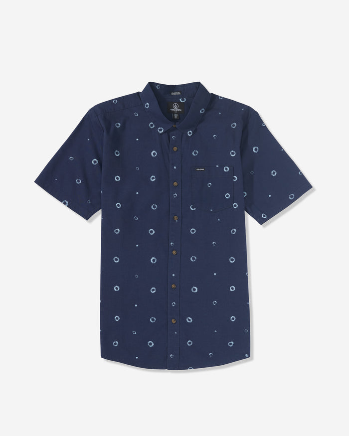 The Volcom Men's Scaler Stone Woven Short Sleeve Shirt in navy blue features subtle circular prints, a front chest pocket, and a button-down collar, shown laid flat on a white background.