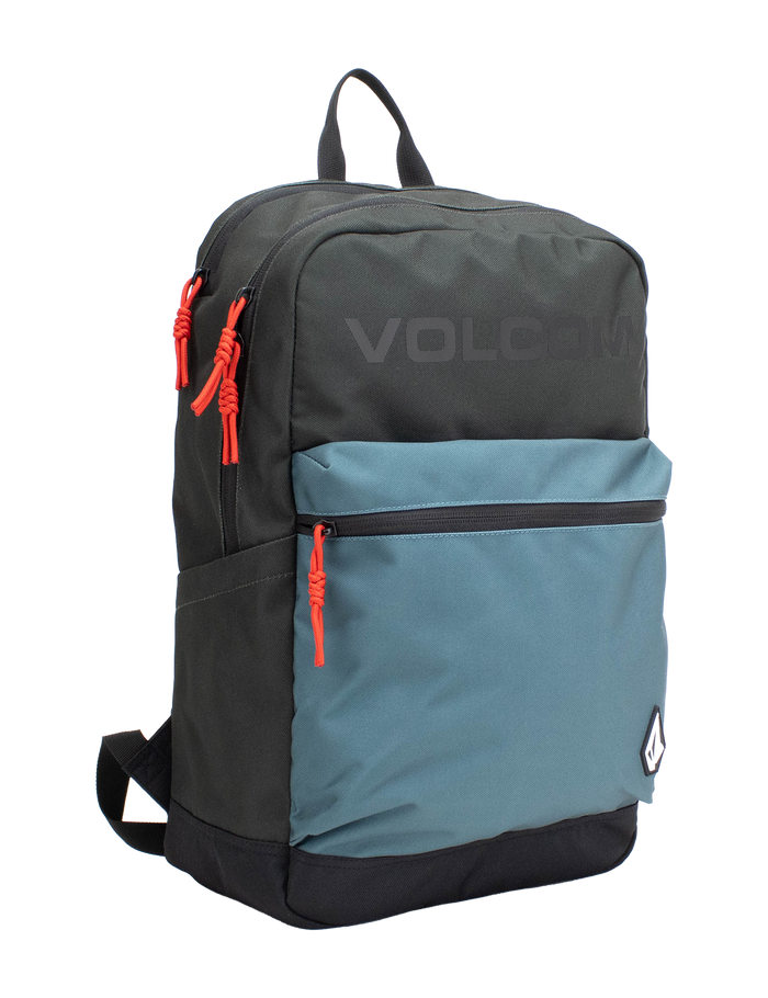 Introducing the Volcom Men's School Backpack in Balsam Green, featuring a black main body, a blue front pocket, and red zipper pulls. A small white Volcom logo accents the lower front, while the brand name is subtly printed near the top. Designed with comfort and practicality in mind, this backpack includes ergonomic straps and a padded laptop sleeve to keep your essentials secure and organized.