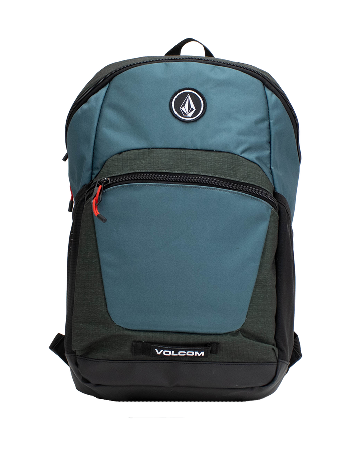 Introducing the Volcom Men's Slam School Backpack in blue and dark green, featuring a spacious main compartment, front zip pocket with a red zipper pull, and a black Volcom logo patch on the upper front. The bottom showcases a white Volcom logo, while the interior includes a padded laptop sleeve for enhanced protection.