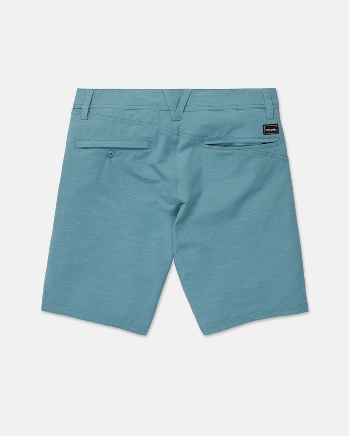 The Volcom Men's Slub Frickin Cross Shred Hybrid Shorts are displayed from the back in light blue, showcasing two rear pockets—one secured with a button—and a small black Volcom label above the right pocket. Designed with a modern fit, these hybrid shorts feature belt loops and a sleek, clean look.