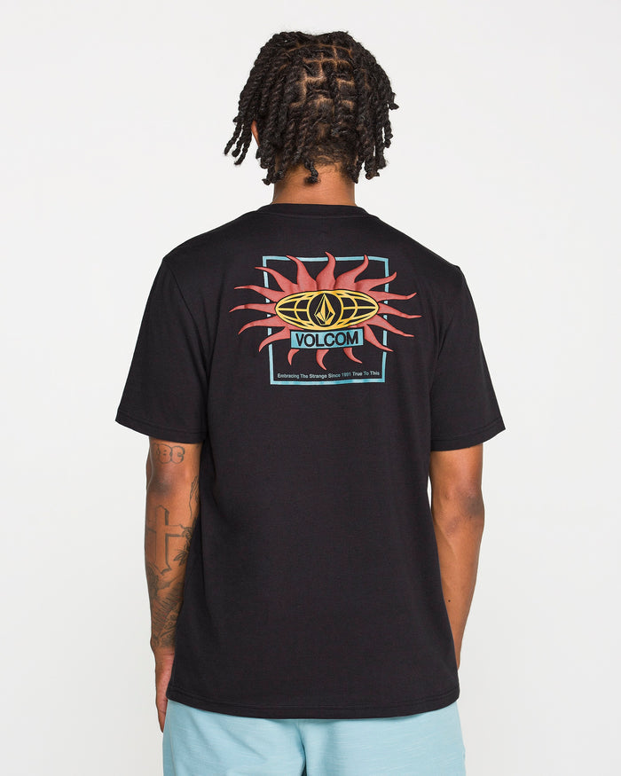 A person with braided hair is seen from behind wearing the Volcom Men's Spf91 Short Sleeve Tee in black heather, which features a vibrant back graphic showcasing the word "Volcom" and a sun motif. Crafted from a soft ring spun cotton-poly blend in a modern fit, this medium-weight T-shirt pairs seamlessly with light blue shorts.