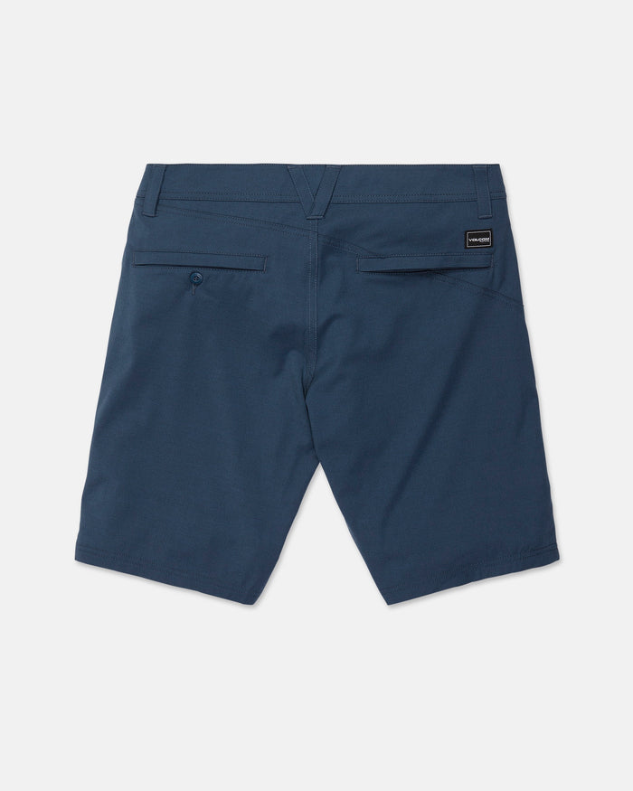Back view of the Volcom Men’s Frickin Cross Shred Static Shorts in blue, featuring two back pockets—one with a button closure. Made from heathered fabric, these shorts have a 20-inch outseam and are detailed with a small black rectangular Volcom label on the right side of the waistband. The shorts are displayed flat on a white background.
