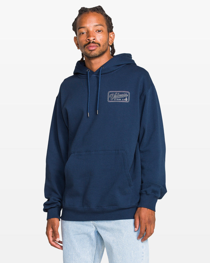 Man wearing a navy blue hoodie with a logo on a white background