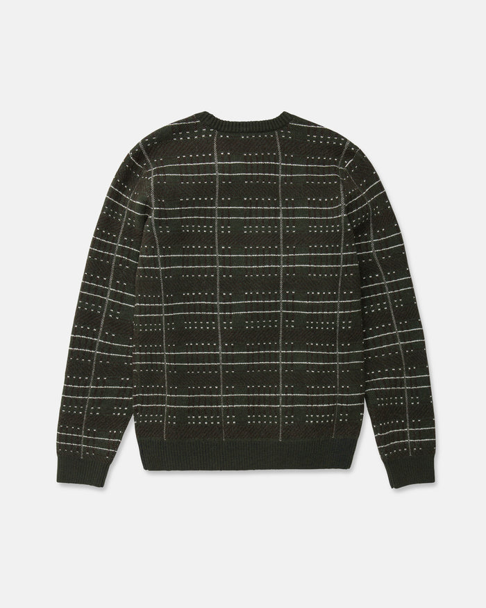 The Volcom Men's Stone Optix Sweater is a dark green slim fit crew neck sweater featuring a white and light green grid pattern with small dotted accents. Shown laid flat with the back facing up, this modern design offers a distinctive look.