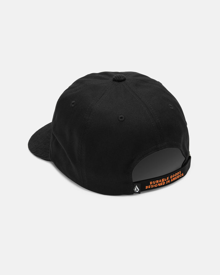 A rear view of the Volcom Men's Stone Talon Workwear Hat—a black canvas 5-panel baseball cap—shows its fabric strap, which is accented by a small orange tag with the text "DURABLE GOODS DESIGNED IN AMERICA" in capital letters.