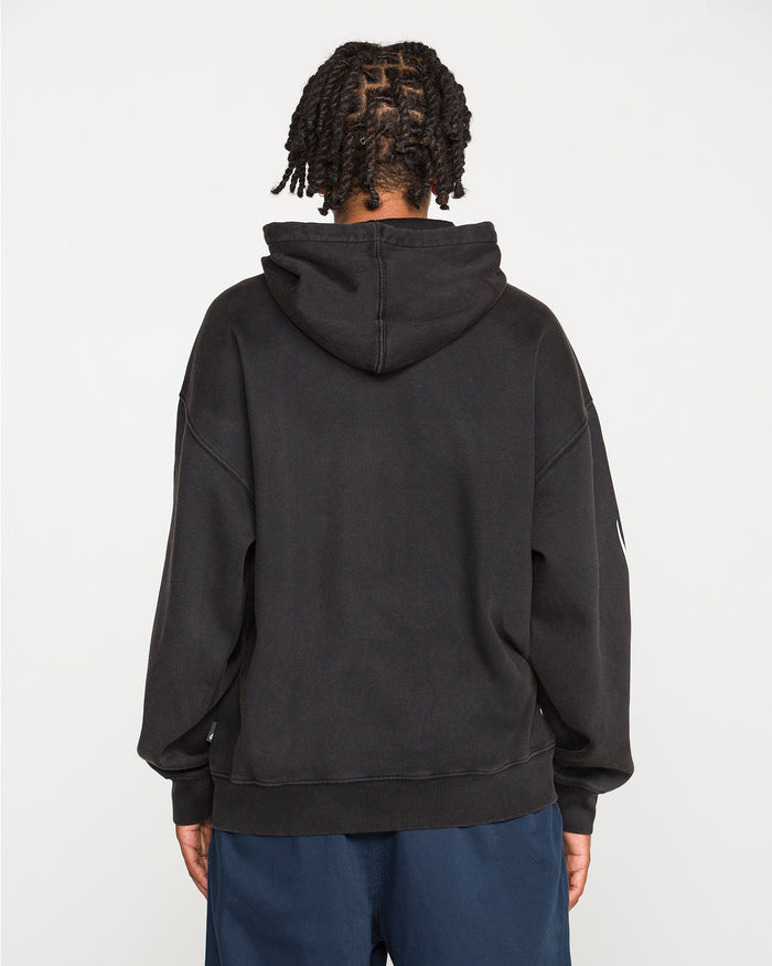 A person with short twisted hair is seen from behind, wearing the Men's Stone Trip Pullover by Volcom—a loose, heavyweight fleece tribal hoodie—paired with dark blue pants, standing against a plain white background.