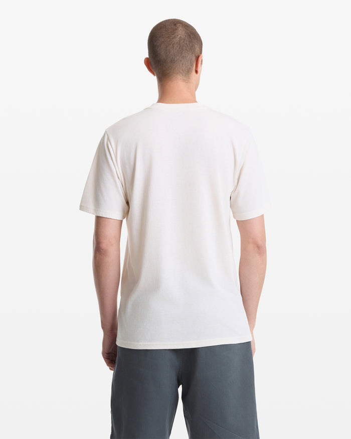 A person with short hair is seen from behind wearing a Volcom Men's Sunnies Short Sleeve Tee in white and dark gray shorts, standing against a white background.