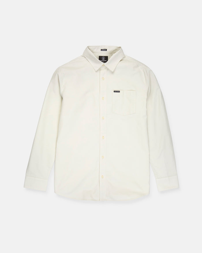 A Volcom Men's Veeco Oxford Long Sleeve Shirt in plain off-white, featuring a classic fit with a pointed collar and single chest pocket, is laid flat on a white background.