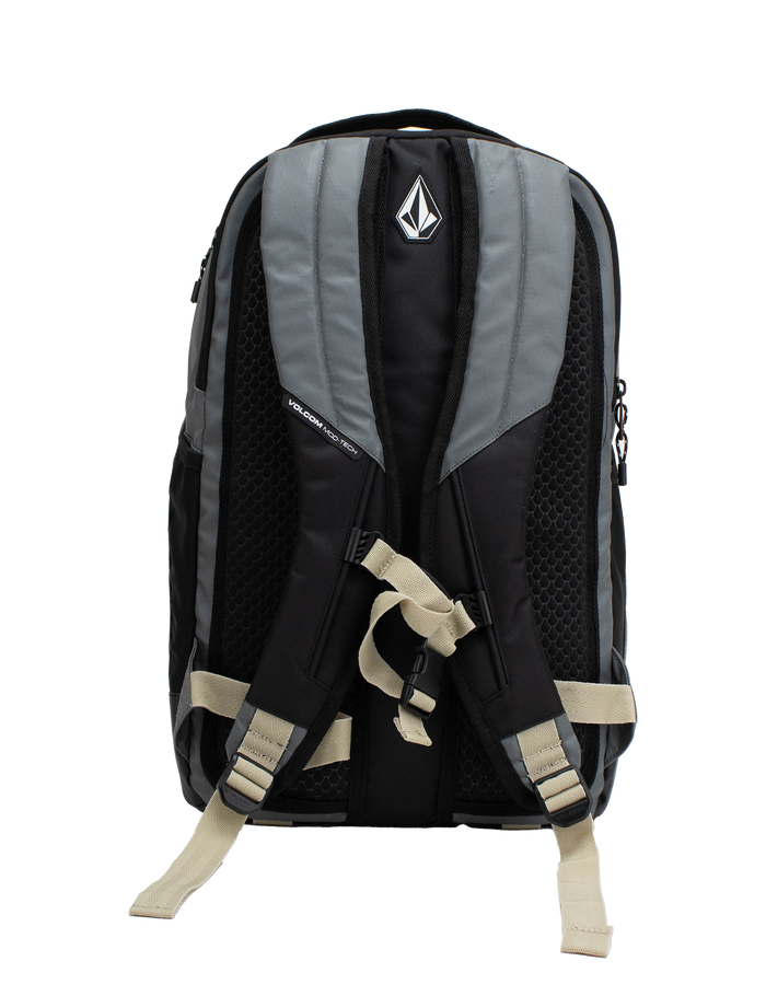 The Volcom Men's Venture Backpack in black and gray features padded shoulder straps, a chest strap, and a geometric Volcom logo on the top section. This 22L backpack includes mesh back padding for comfort and a padded laptop sleeve for extra protection. The bag is shown standing upright against a white background.