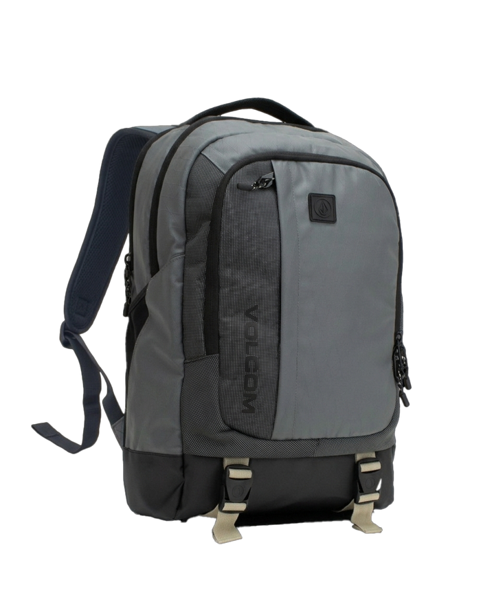 The Volcom Men's Venture Backpack in gray and black offers adjustable straps, multiple zippered compartments, and two buckle closures at the bottom front. With a 22L capacity, this backpack features a padded back, sturdy top handle, and a padded laptop sleeve for added convenience.