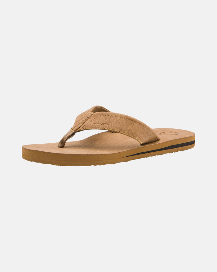 The Volcom Men's Victor LX Sandals feature a brown color, a fabric thong strap, flat sole, and water-friendly technology, shown against a plain white background.
