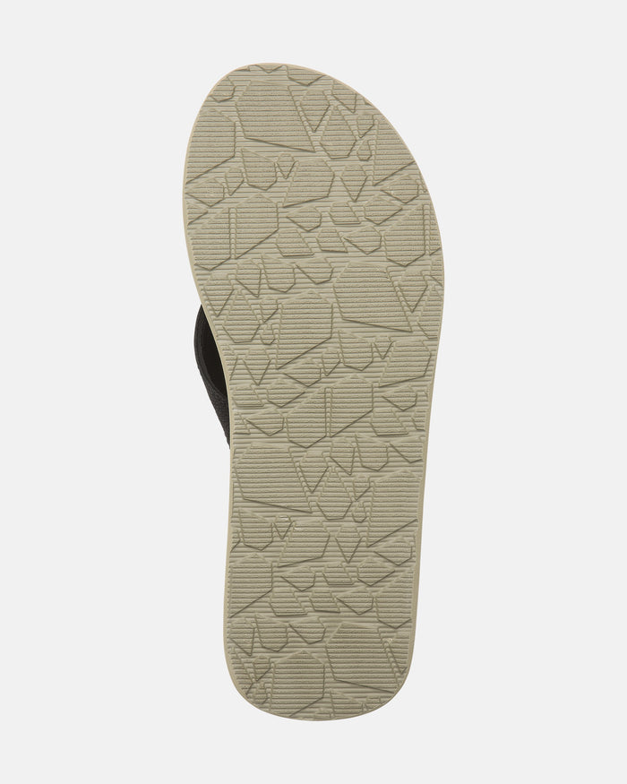 The Volcom Men's Victor Sandals LX feature a beige sole with a textured, irregular geometric tread, designed for added grip. Recliner Comfort Foam provides extra cushioning. Shown here on a white background.