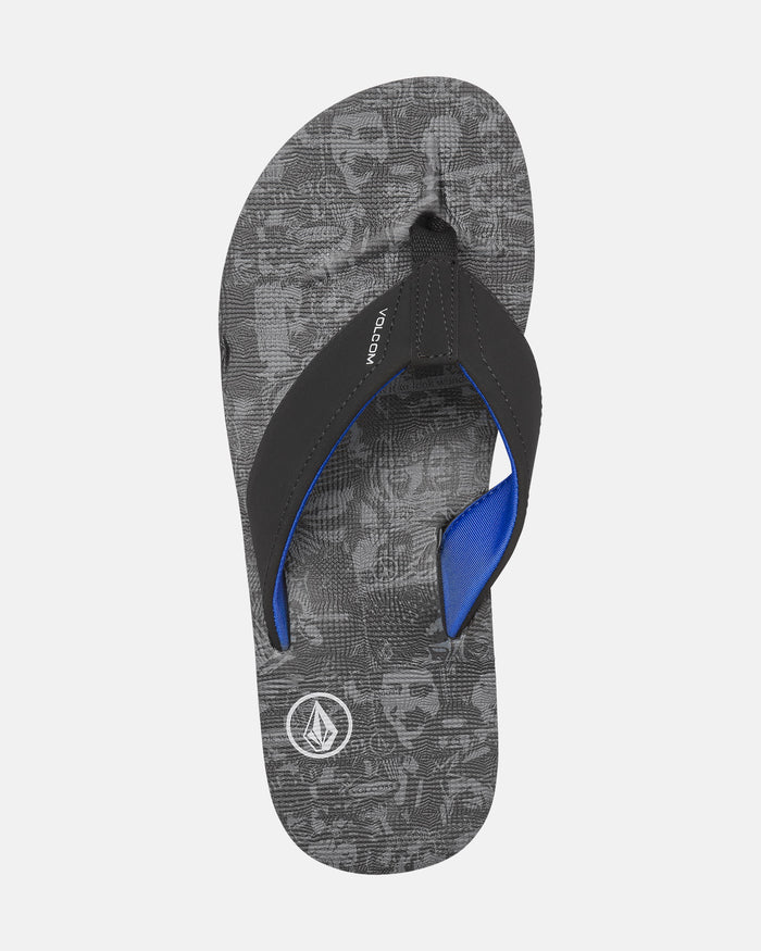 The Men’s Victor Sandals by Volcom feature a black and gray design with textured soles, Recliner Comfort Foam, black straps lined in bright blue, and the Volcom logo near the heel. Water-friendly, they’re perfect for everyday wear.