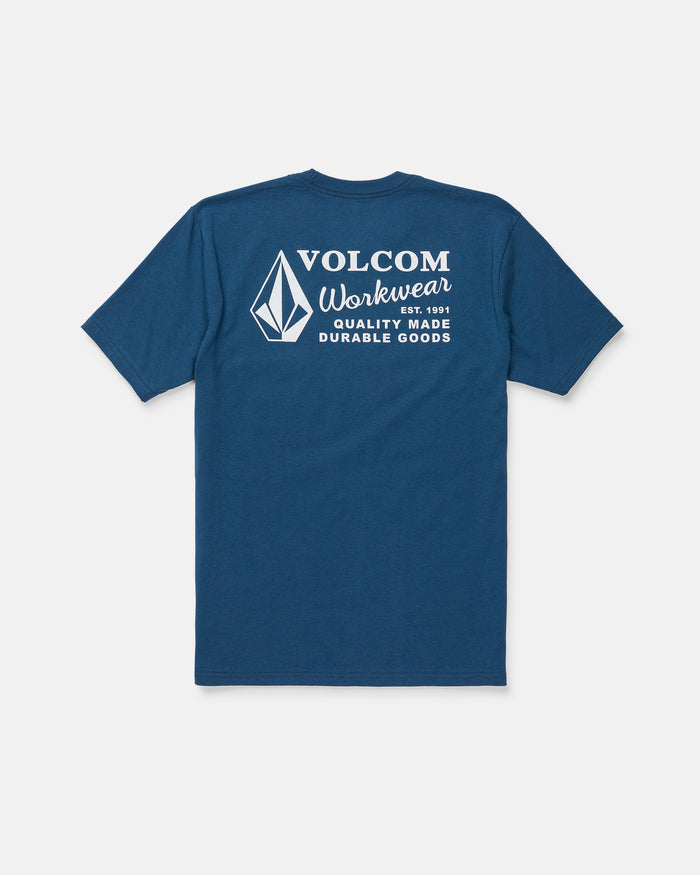The Men's Volcom Workwear Short Sleeve Tee by Volcom is featured in blue, displayed from the back with a white diamond emblem and logo. The upper back showcases the text “Volcom Workwear, Quality Made Durable Goods.” Crafted from heavy-weight cotton, this classic fit tee is designed for long-lasting comfort and durability.