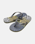 The Men's Volcomotion Mens flip-flops by Volcom feature black straps and a vibrant, abstract blue, yellow, and white wavy pattern on the soles—perfect for summer comfort and classic style. Displayed on a plain white background.