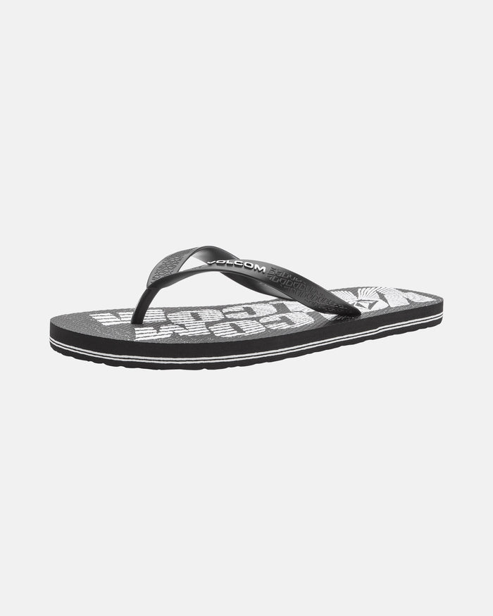 The Volcomotion Mens flip-flop by Volcom is a black sandal with a textured sole, white graphic text, and a branded black strap, shown against a plain white background.