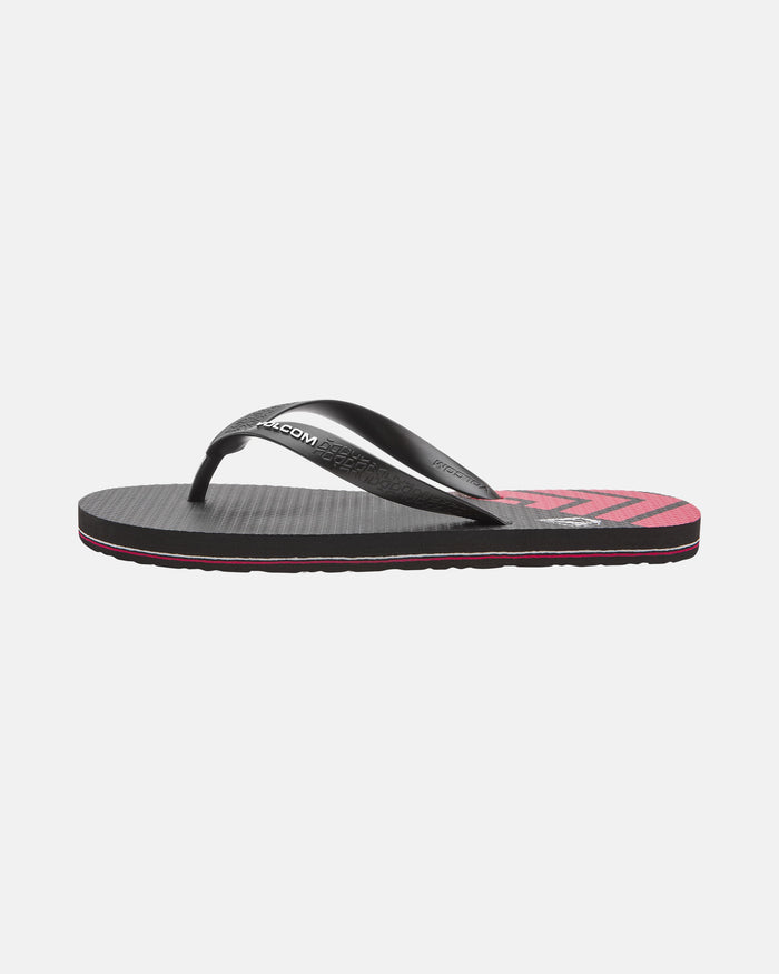 The Volcom Volcomotion Mens is a black and pink flip-flop sandal with a textured sole and black thong strap, shown on a plain white background.
