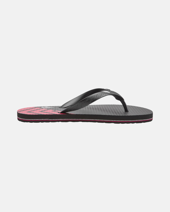 The Volcomotion Mens by Volcom is a black flip-flop sandal featuring a textured sole and pink detailing on the bottom, shown from the side against a plain white background.
