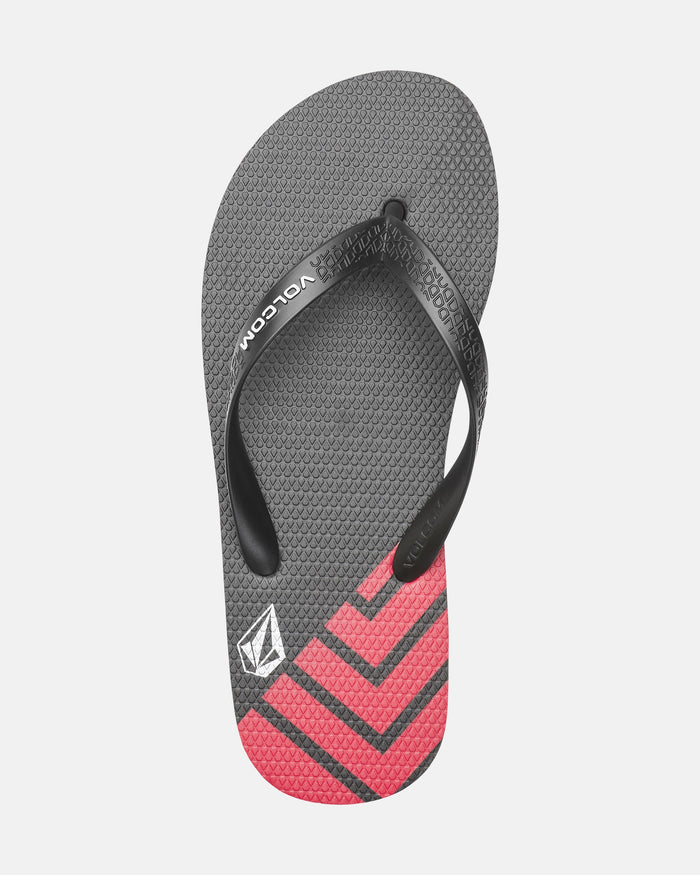 A single Volcomotion Mens gray flip-flop sandal by Volcom, with black straps, Volcom logo and brand name, a textured footbed, and red chevron stripes near the toe area.