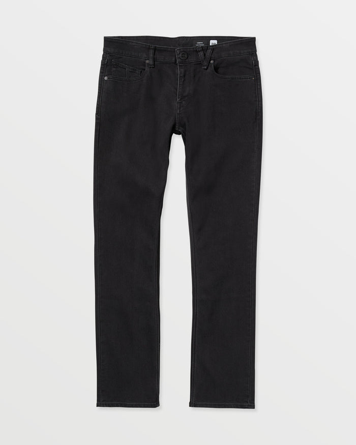 The Volcom Vorta Denim features a classic five-pocket design in black stretch denim with a slim, straight-leg fit, shown laid flat on a white background.