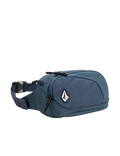 The Men's Waisted Pack by Volcom features a blue design with a black zipper, adjustable strap, and a white Volcom logo patch on the front pocket, making it perfect for keeping your essentials hands-free during outdoor adventures. Shown against a white background.