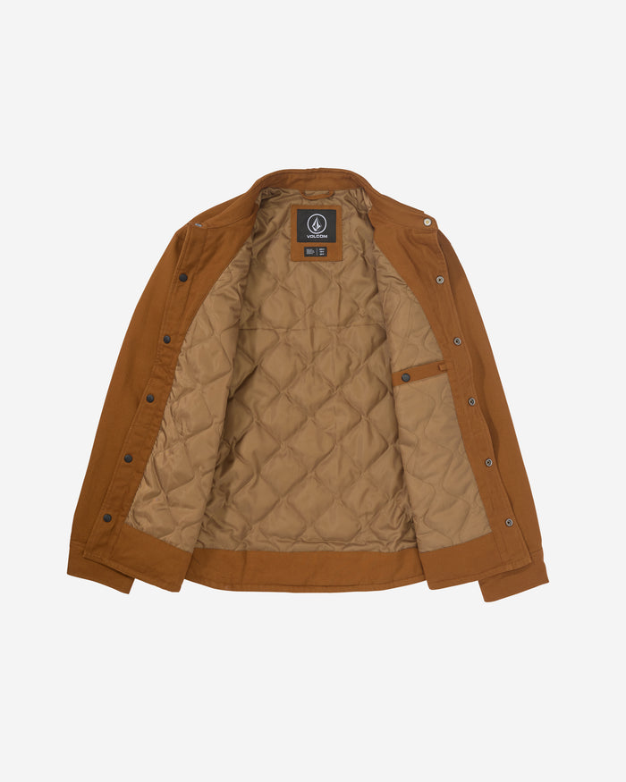 The Men's Westmead Jacket by Volcom is shown laid flat on a white background, open to display its snap-button closure, an interior pocket, quilted tan lining, and a black Volcom label inside the collar.