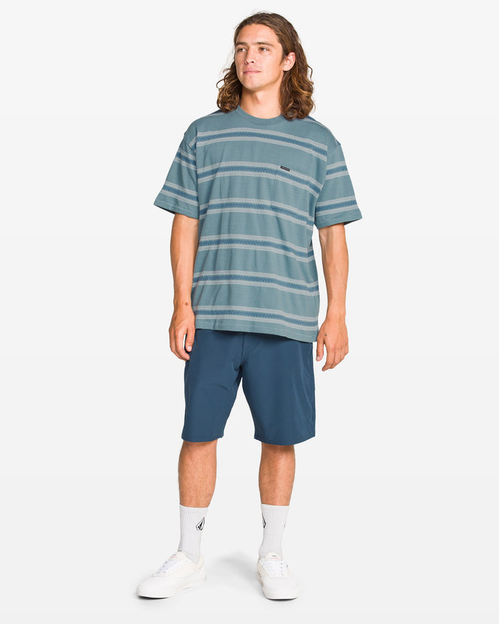Man wearing a striped t-shirt and shorts on a white background
