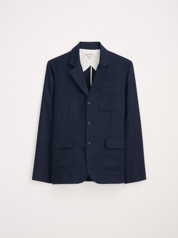 The Mercer Linen Jacket in navy blue features a single-breasted design with three buttons, notched lapel, and three front pockets for a lightweight tailored fit, shown against a plain white background.