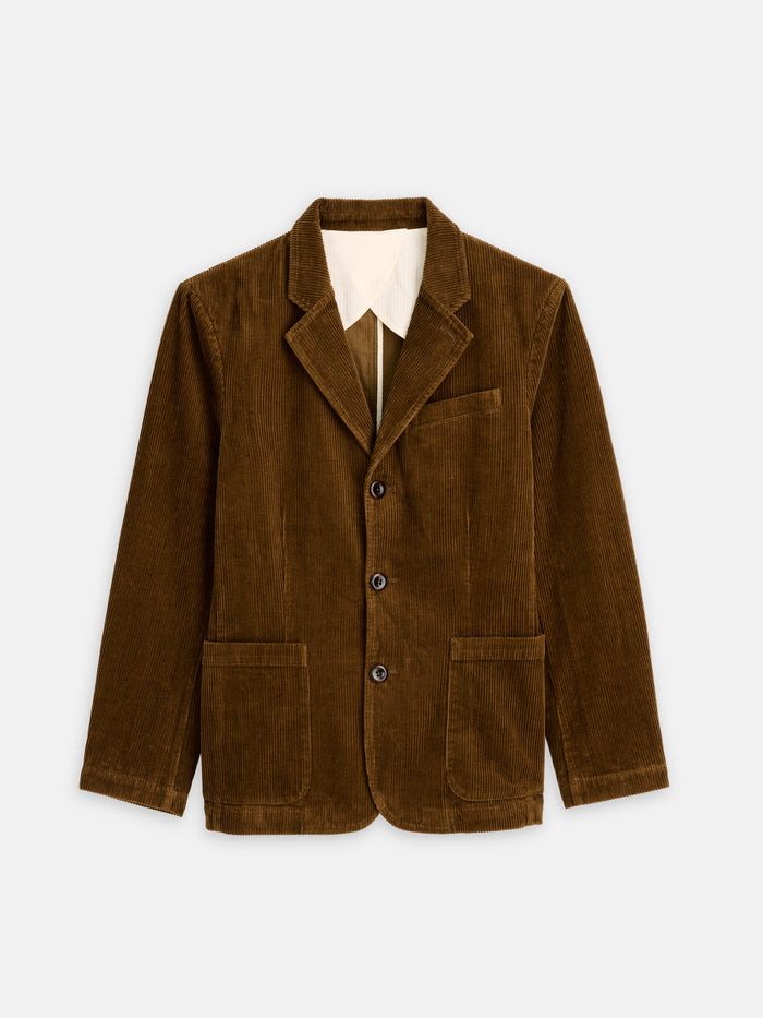 The Mill Blazer in Corduroy is a brown, fully lined men’s casual blazer with three buttons, two front pockets, and a chest pocket. It is shown laid flat on a white background.