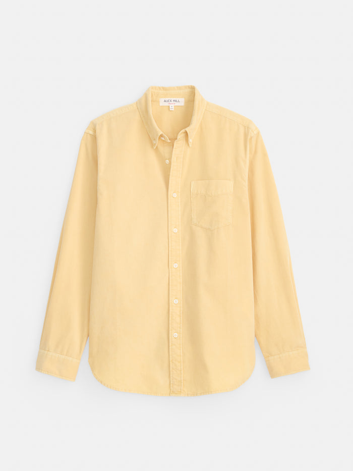 Here’s a rewritten sentence using the product data provided: The Mill Shirt in Fine Wale Corduroy is a long-sleeve, button-down shirt in light yellow, crafted from 100% cotton corduroy and featuring a front chest pocket, shown against a plain white background.