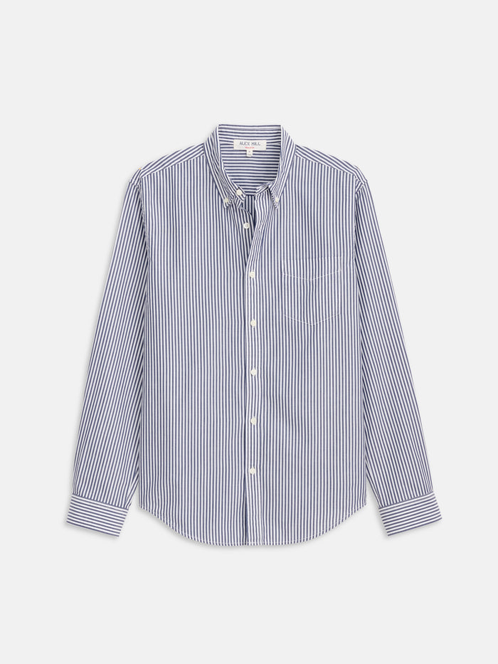 The Mill Shirt in Stripe Portuguese Poplin is a lightweight men’s cotton shirt with blue and white vertical stripes, a button-down collar, and chest pocket, crafted from premium Portuguese cotton.