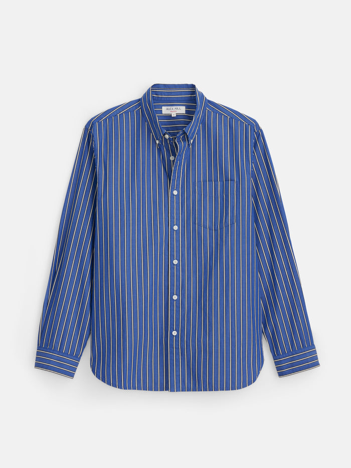 Mill Striped Shirt in Cotton Poplin: A blue, long-sleeve button-down shirt with white vertical stripes and a chest pocket, crafted from 100% cotton poplin. The shirt is displayed flat against a white background.