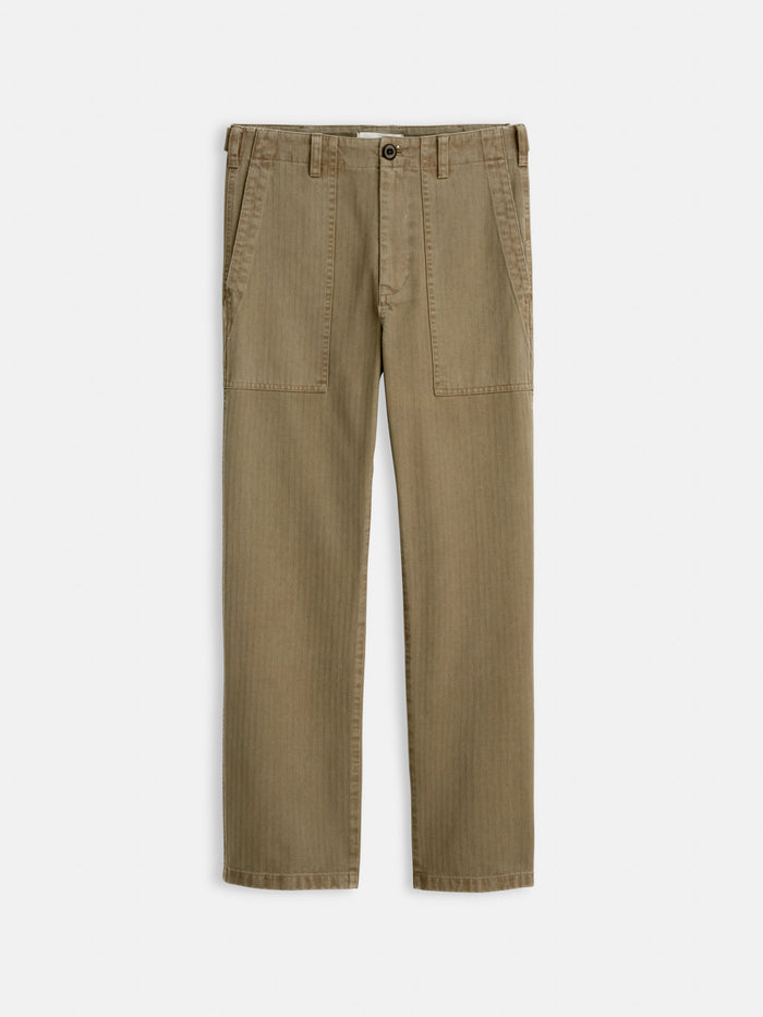 The Neil Pant In Herringbone: garment-dyed khaki straight-leg cotton pants with front patch pockets and belt loops, shown flat on a white background.