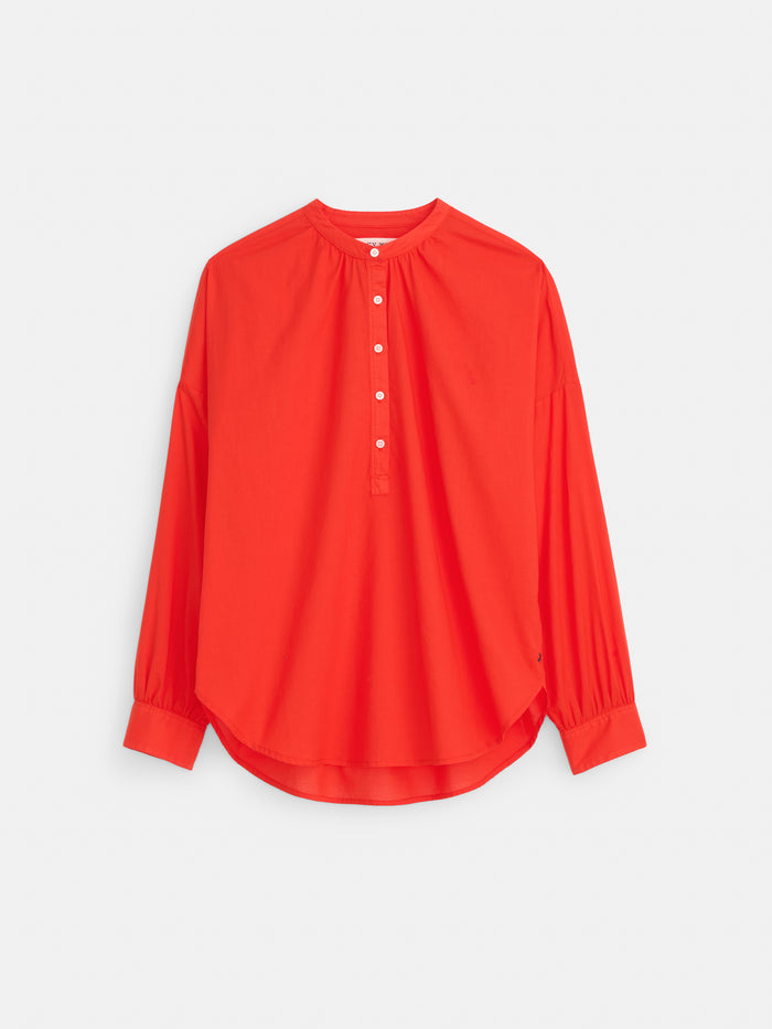 The Nina Striped Popover in Cotton Voile is a relaxed fit women's shirt with long sleeves, a round neckline, partial button placket, cuffed sleeves, and a curved hem, shown against a plain white background.