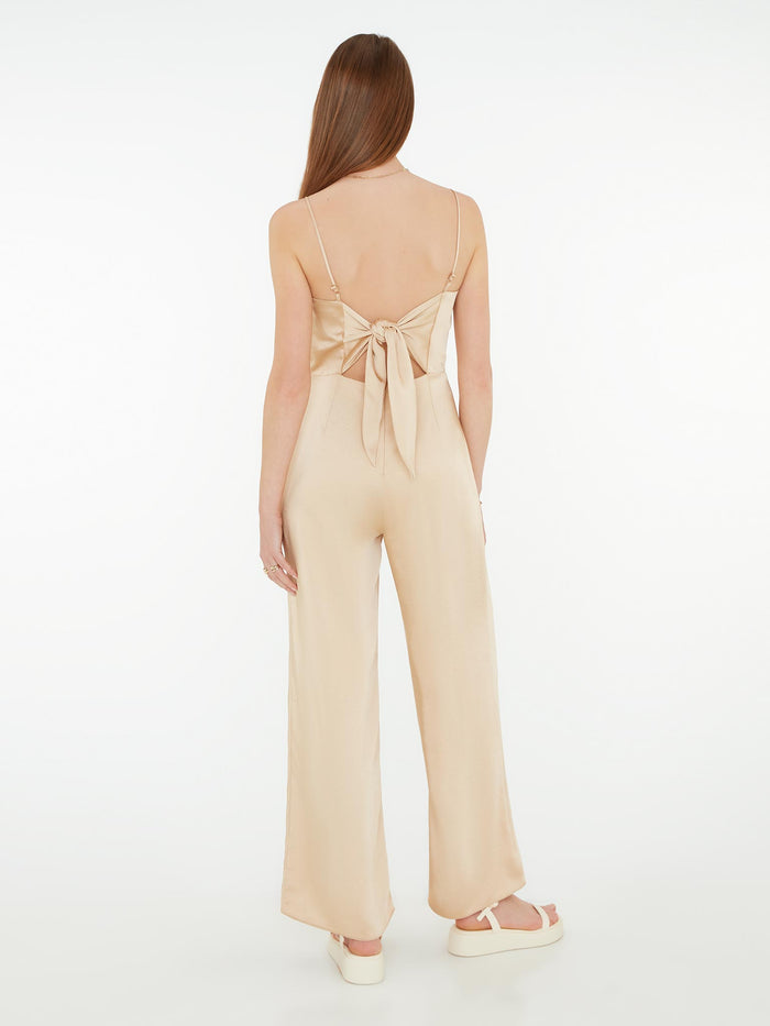 strappy jumpsuit in gold with tie back detail