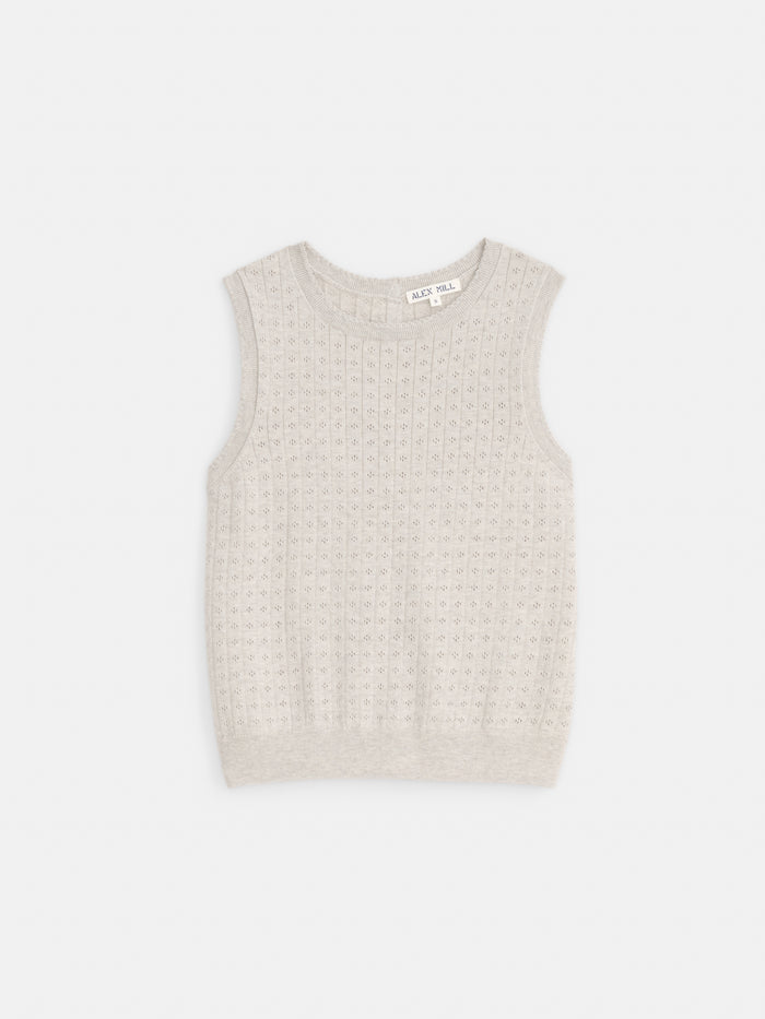 The Odette Sweater Tank in Cotton Cashmere is a sleeveless, light gray vest featuring a subtle textured pattern and feminine fit, shown against a plain white background.