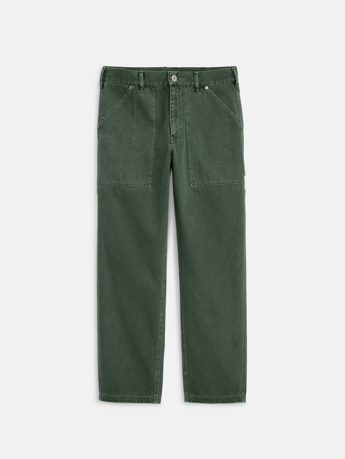 The Painter Pant In Recycled Denim features a relaxed fit in dark green, with front patch pockets, belt loops, and a button closure, shown laid flat on a white background.