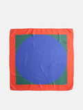 The Pop Art Silk Scarf features a square design with a red border, a green inner square, and a large blue oval centered on the fabric.