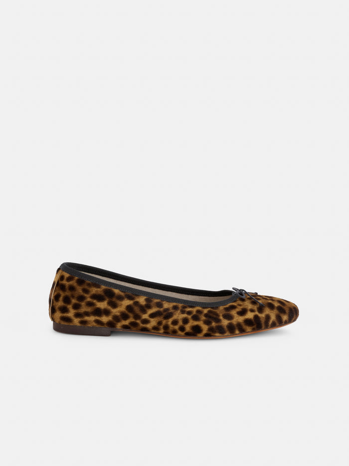 The Prince Street Ballet Flat in Calf Hair, handmade in Florence from luxurious Italian leather with a leopard print and finished with a small black bow on the toe, is shown from the side against a plain white background.