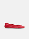 A side-profile view of the Prince Street Ballet Flat in red, featuring a small bow on the toe and a light brown flat sole, set against a plain white background.