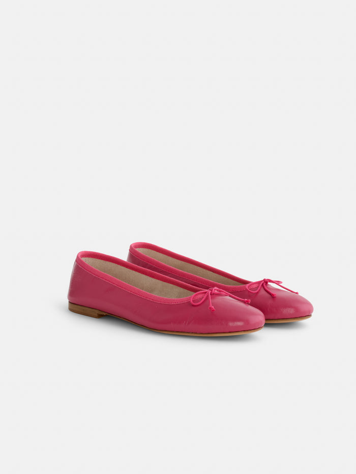 A pair of bright pink Prince Street Ballet Flats with small toe bows, handmade in Florence, displayed against a plain white background.
