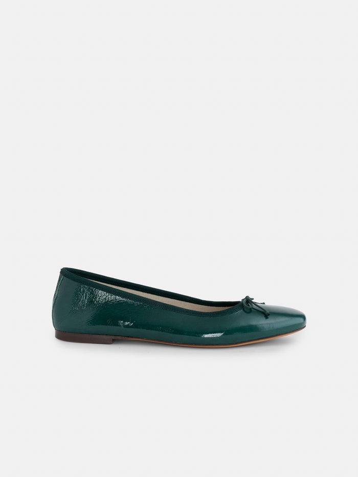 The Prince Street Ballet Flat in Patent Leather is a dark green, handmade Italian ballet flat featuring a small bow on the toe, shown from the side against a plain white background.