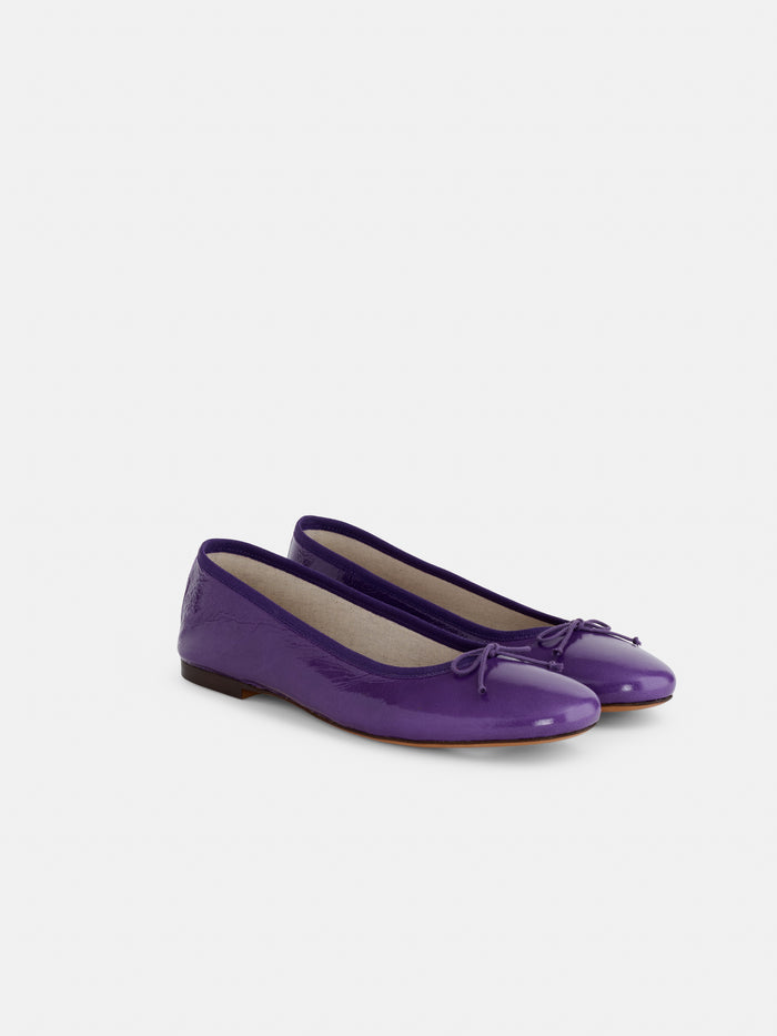 A pair of Prince Street Ballet Flats in shiny purple patent Italian leather, featuring small decorative bows on the toes, handmade in Italy and displayed on a plain white background.