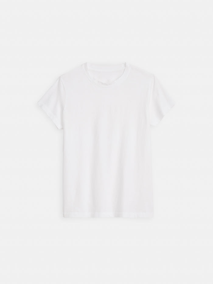 The Prospect Tee In Cotton Jersey, a plain white short-sleeve crew neck made from 100% cotton, is garment-dyed and displayed flat on a white background.